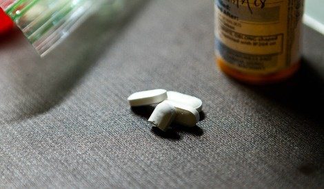 Close up photo of pill bottle and pills, illustrating adoption and drug addiction